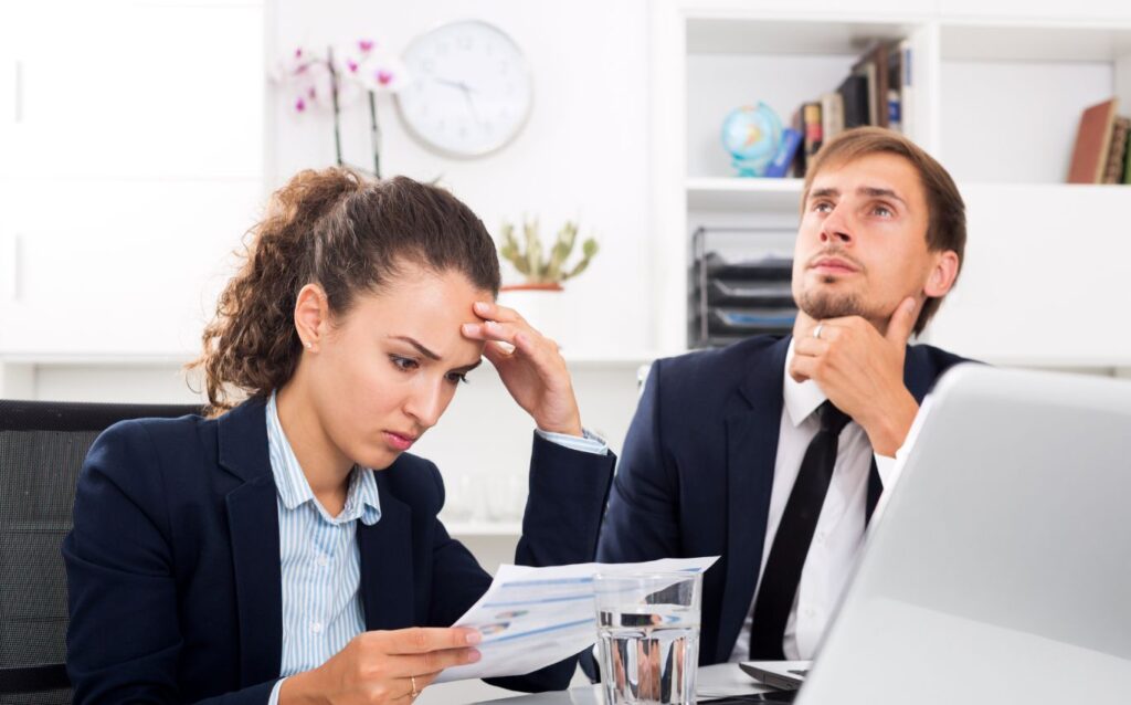 a woman holding her head because making mistakes at work