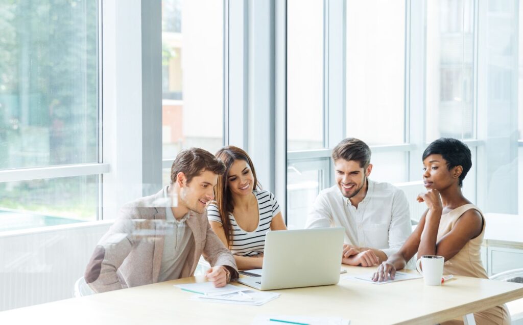 employees gathering together talking about social skills at the meeting room in the office