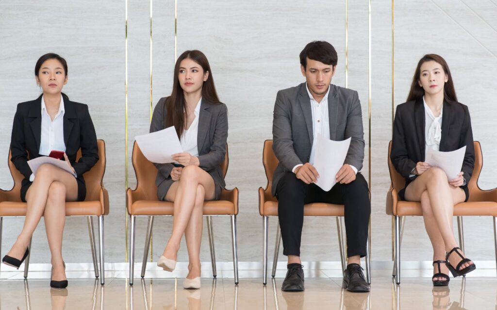 the candidates are waiting for their turn to interview and wear decent outfit for a job interview such as shirts and suits or blazers